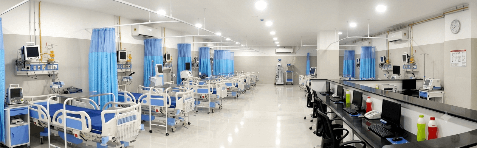 Hospital ICU ward setup featuring motorized hospital beds, cardiac monitors, and medical gas supply points